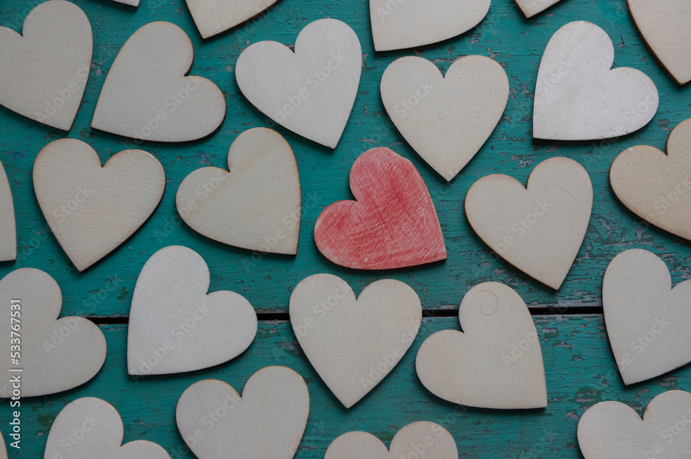 Obraz premium Love Valentines day background, group of light wooden hearts spread on vintage blue green scratched table, flat lay one by one