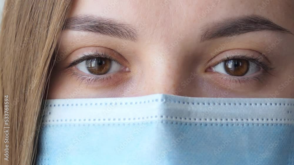 Young woman takes off medical mask. Female breathes deeply and smiling looking at camera. Isolated on white background. Health care and medical concept. Close up portrait Young woman takes off medical mask. Female breathes deeply and smiling looking at camera. Isolated on white background. Health care and medical concept. Close up portrait