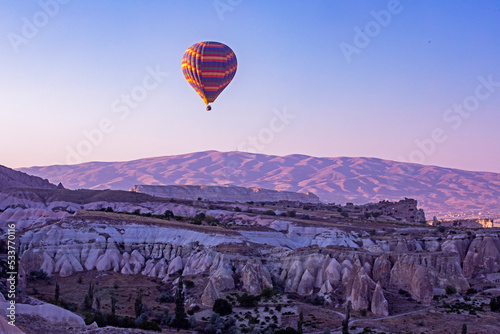 hot air balloon flight in the early lilac morning in the Goreme valley