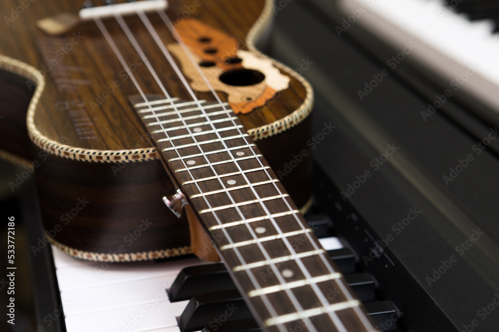 Fototapeta premium Ukulele guitar and piano keyboard
