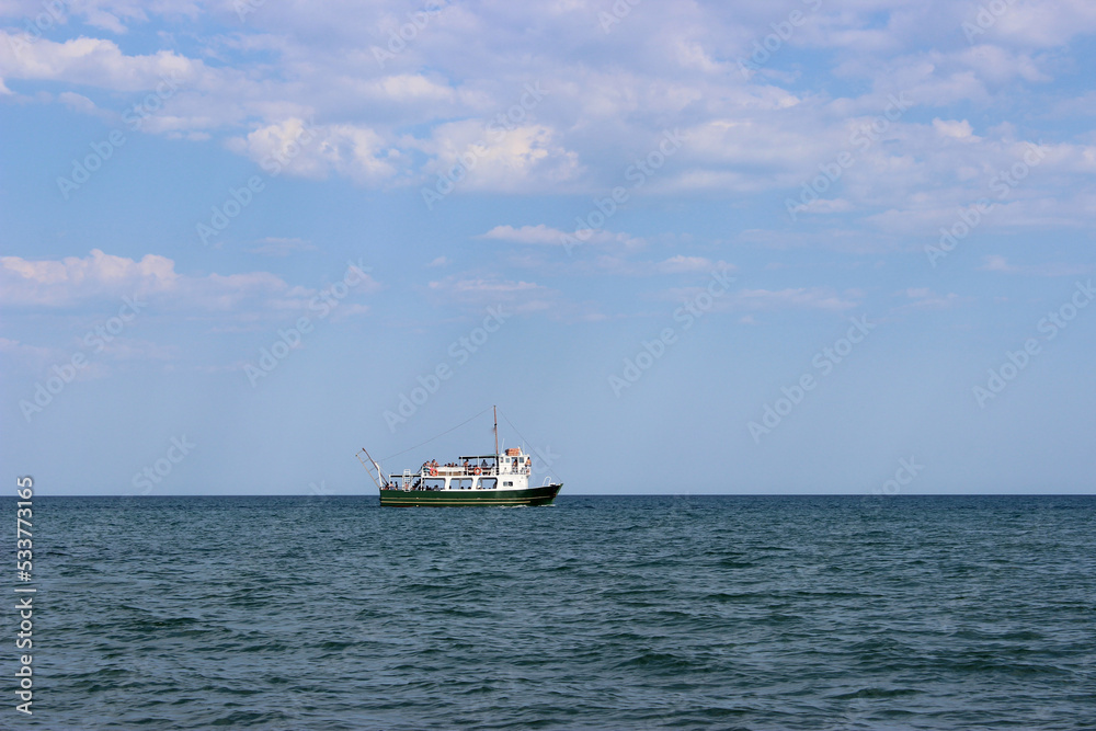 fishing boat in the empty blue sea. Landscape of the sea with a fishing boat 