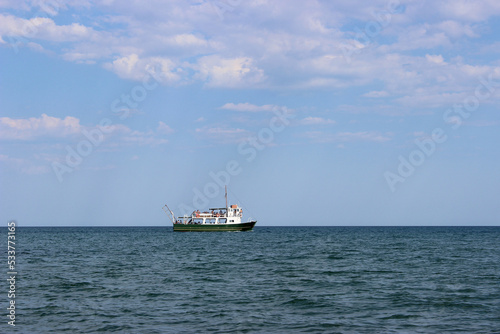fishing boat in the empty blue sea. Landscape of the sea with a fishing boat  © Stefanija
