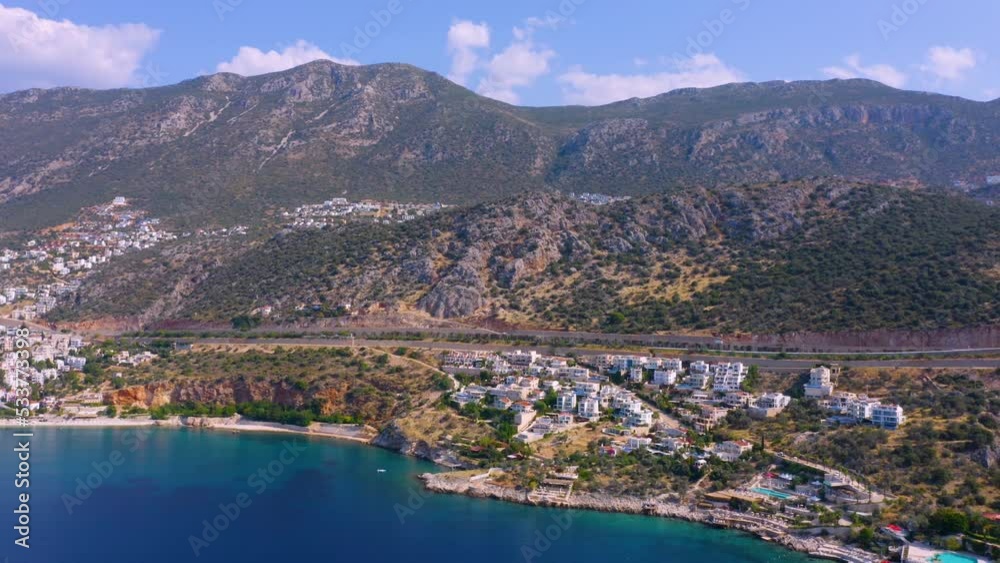 Beautiful aerial view of cityscape by sea on the background of mountains. Picturesque nature landscape from above. Beautiful aerial view of cityscape by sea on the background of mountains. Picturesque nature landscape from above.