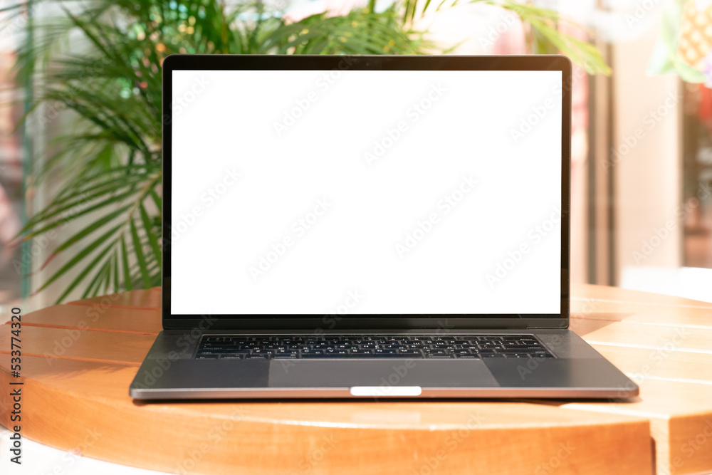 Laptop with white screen in vacation situation. Empty copy space, blank screen mockup. Soft focus laptop with interor background. Vacation, treveling and remote work concept Laptop with white screen in vacation situation. Empty copy space, blank screen mockup. Soft focus laptop with interor background. Vacation, treveling and remote work concept