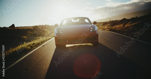 Wallpaper Mural Red sports car driving on desert road, exhilarating sunset drive Torontodigital.ca