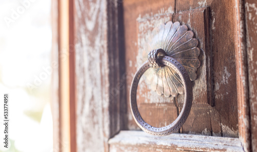 Old wooden weathered door, with antique brass knob