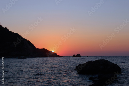 sunset over the sea with shore cliff  © Stefanija