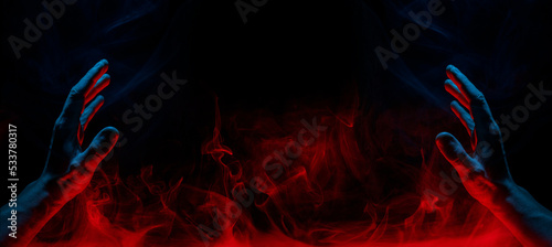A scary hand on dark background. Mysterious composition. Fortune teller, mind power, prediction, halloween concept. Wide angle horizontal wallpaper or web banner. Mockup for your logo.