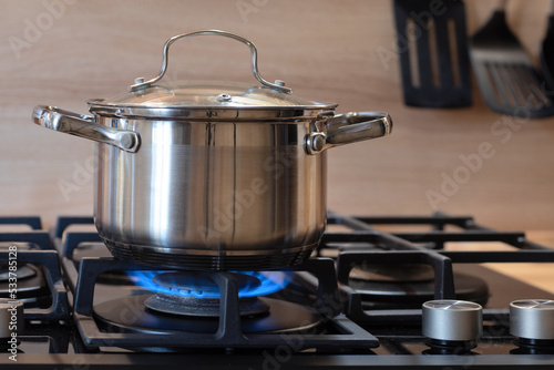 pot on gas stove, stainless pan on the hob, cooking on a gas stove, the cost of gas in Europe