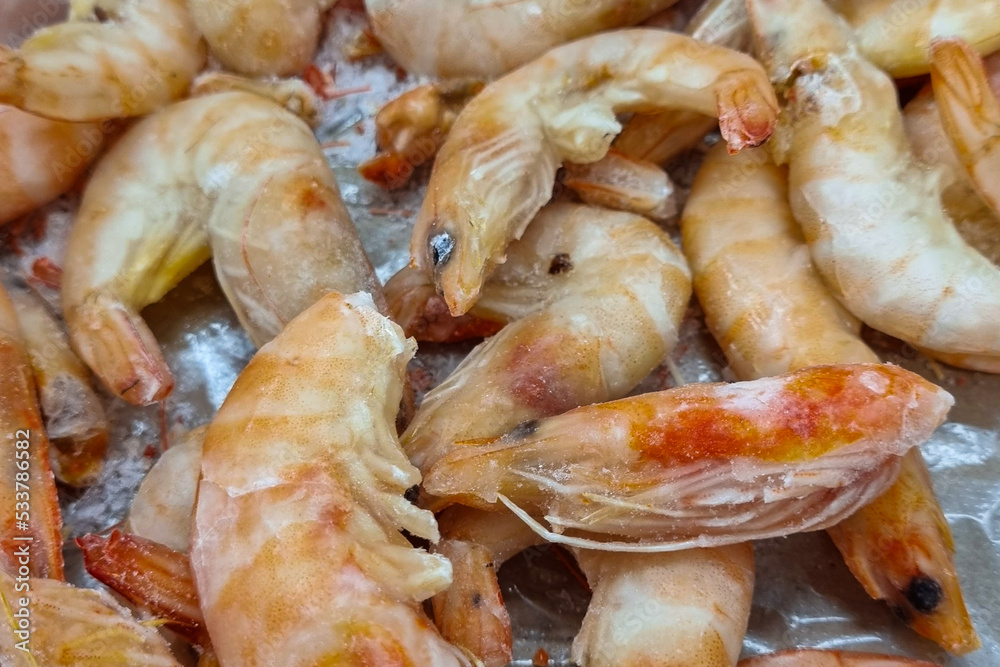 Frozen shrimp. Seafood on the counter. Fish market. Close-up shooting of seafood. Frozen shrimp. Seafood on the counter. Fish market. Close-up shooting of seafood.