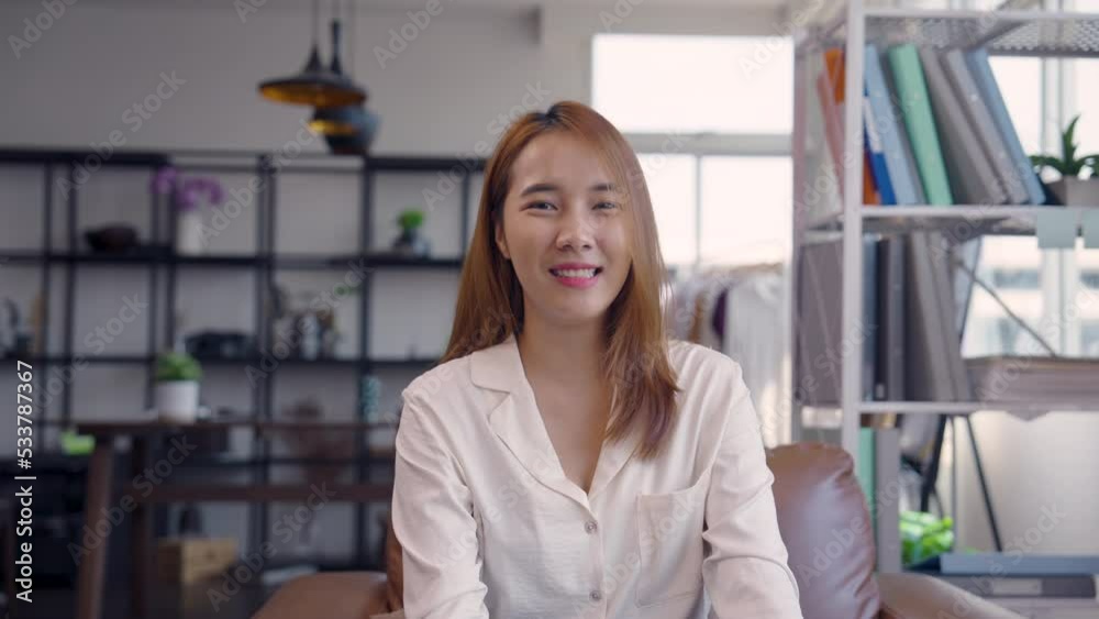 Close up portrait young Asian woman smiling in office Close up portrait young Asian woman smiling in office
