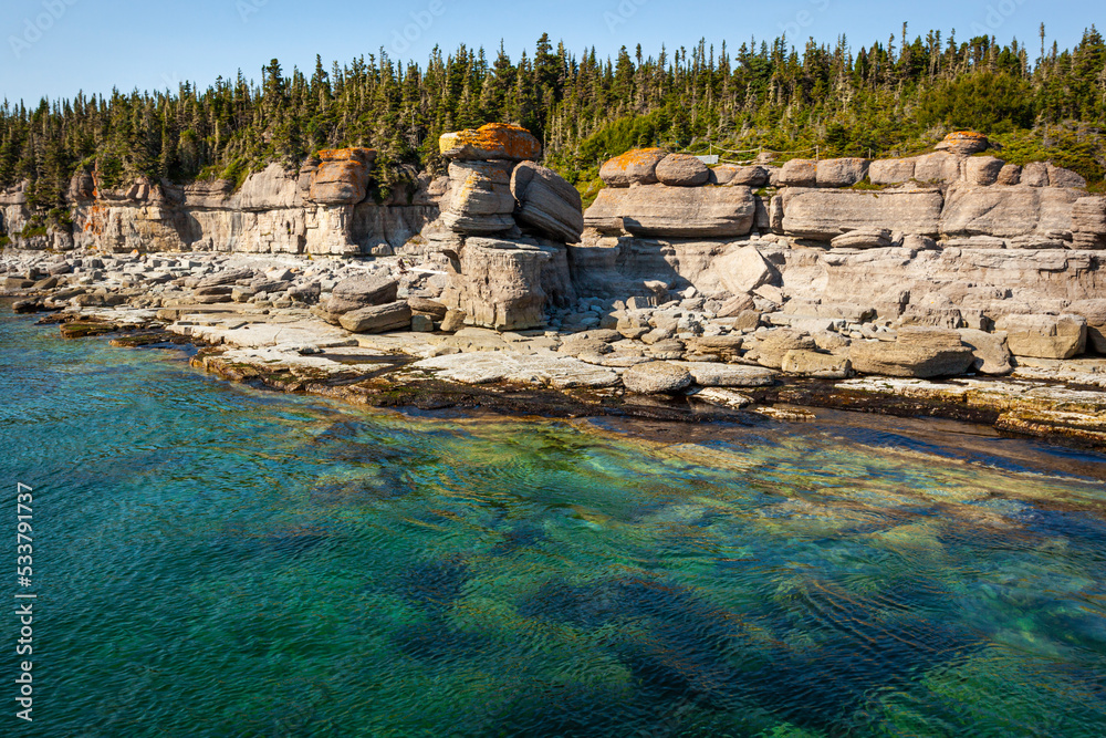 Obraz premium Monoliths under a beautiful blue sky in Mingan Archipelago National Park Reserve of Canada, Quebec, Canada