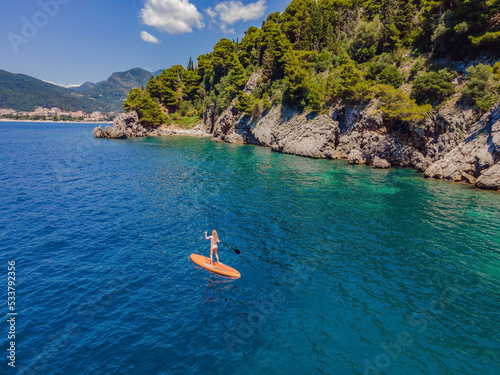 Photography Young women Having Fun Stand Up Paddling in blue water sea in Montenegro