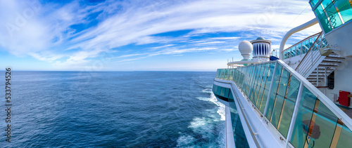 Panoramic ocean view of luxury cruise ship deck heading to a family cruise vacation in open sea.