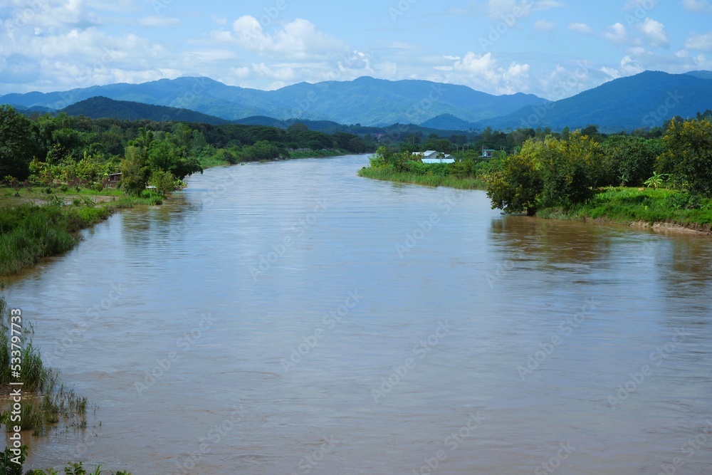 The river flowing from the high mountains behind The river flowing from the high mountains behind