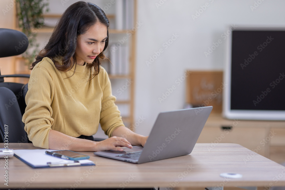 Smiling indian woman using laptop at home, Happy Young asian businesswoman send email and working at home. Asian freelancer typing on computer with paperworks and documents on table. Smiling indian woman using laptop at home, Happy Young asian businesswoman send email and working at home. Asian freelancer typing on computer with paperworks and documents on table.