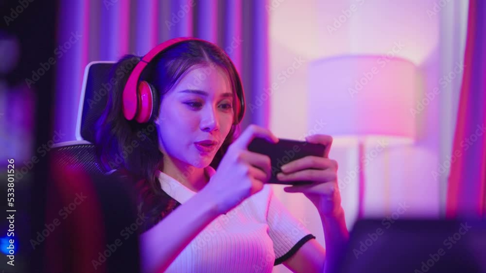 Asian frustrated esport woman gamer playing online mobile game at home
Asian frustrated esport woman gamer playing online mobile game at home