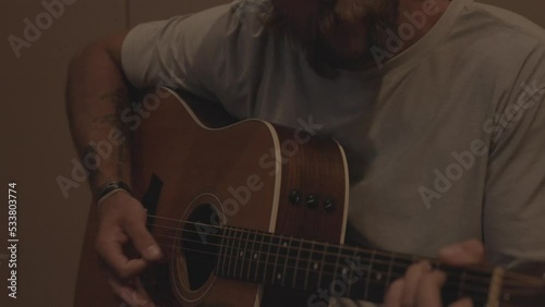 Man Playing Guitar in Recording Studio Booth