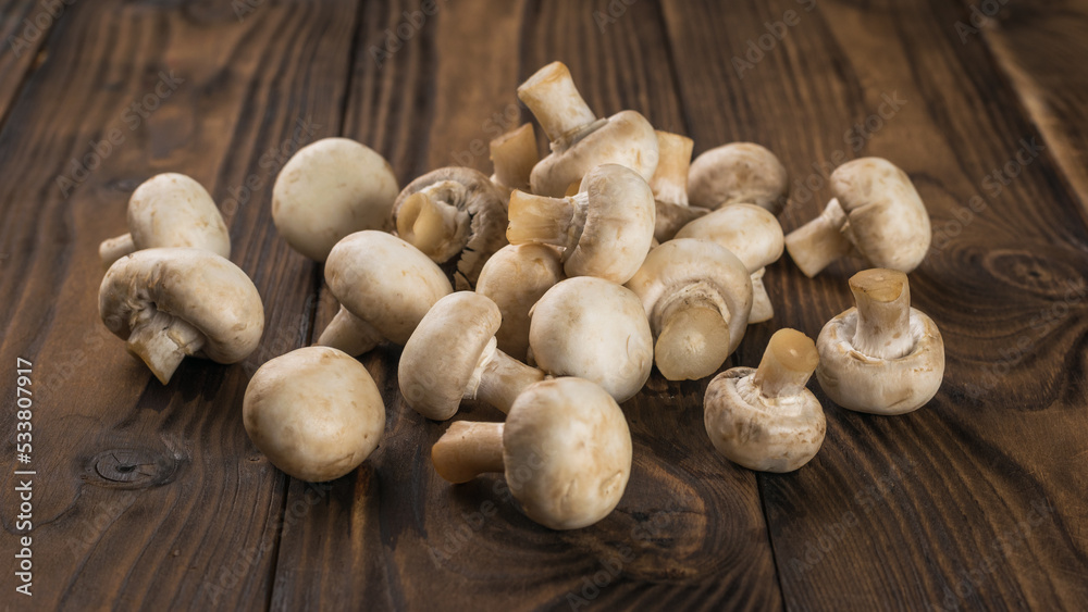A bunch of fresh mushrooms on a rustic background. A bunch of fresh mushrooms on a rustic background.