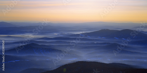 Colorful mountain hills with tonal perspective at winter evening at sunset. Abstract panoramic landscape in Gornaya Shoria, Sheregesh ski resort in Russia Foggy Mountains nature environment © yrabota