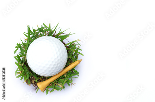 golf ball and tee on grren grass with copy space