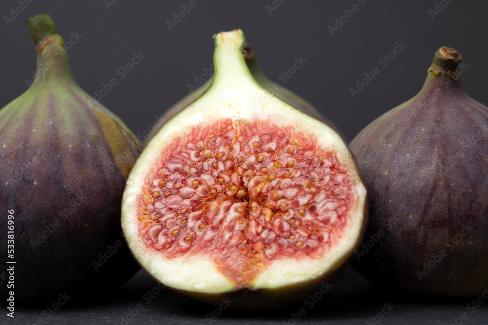 Figs cut into pieces on a black background close-up Figs cut into pieces on a black background close-up