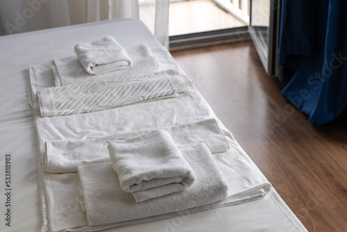 White clean towels in the hotel room on the bed © Olga