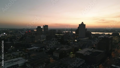 Drone Flying during Sunset around Buildings in Downtown Memphis, Tennessee with the Mississippi River Bridge in the background.