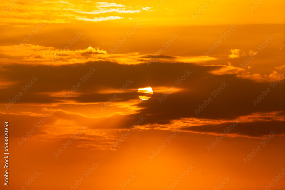 Telephoto photo of yellow orange sunset sunrise, clouds, sky golden hour