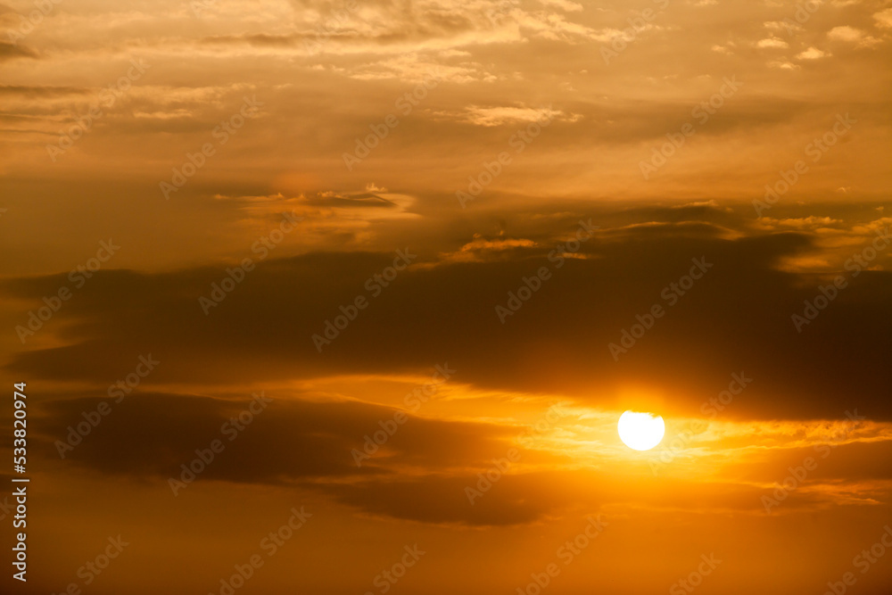 Telephoto photo of yellow orange sunset sunrise, clouds, sky golden hour. golden