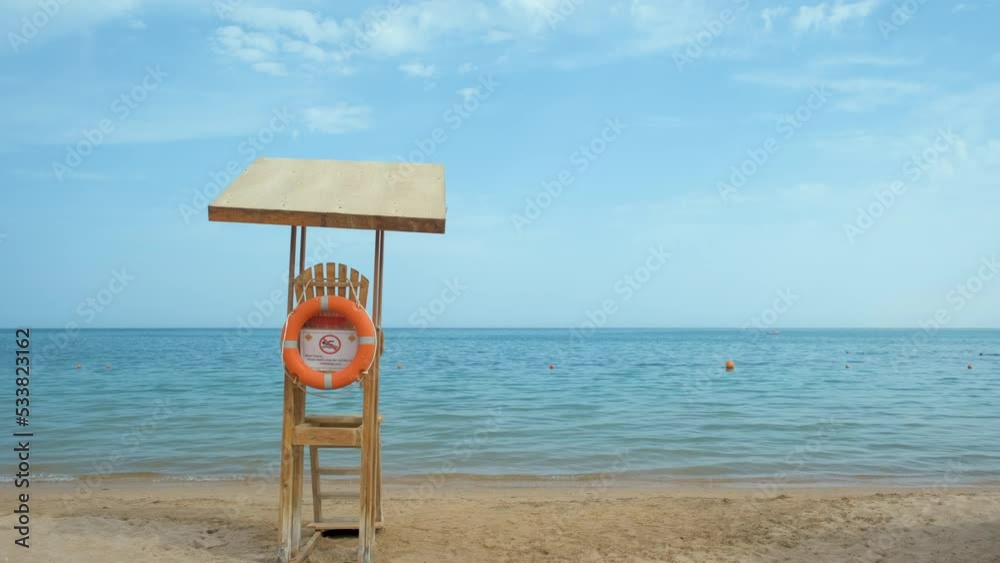 Empty wooden lifeguard station on sandy beach on ocean shore in summer Empty wooden lifeguard station on sandy beach on ocean shore in summer