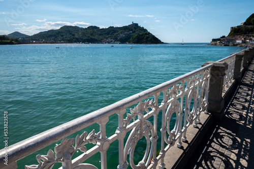 Walking near La Concha sandy beach in San Sebastian or Donostia city, touristic destination in Basque Country, north of Spain © barmalini