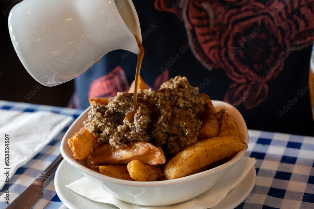 Scottish traditional snack food, hand cut potato chips topped with