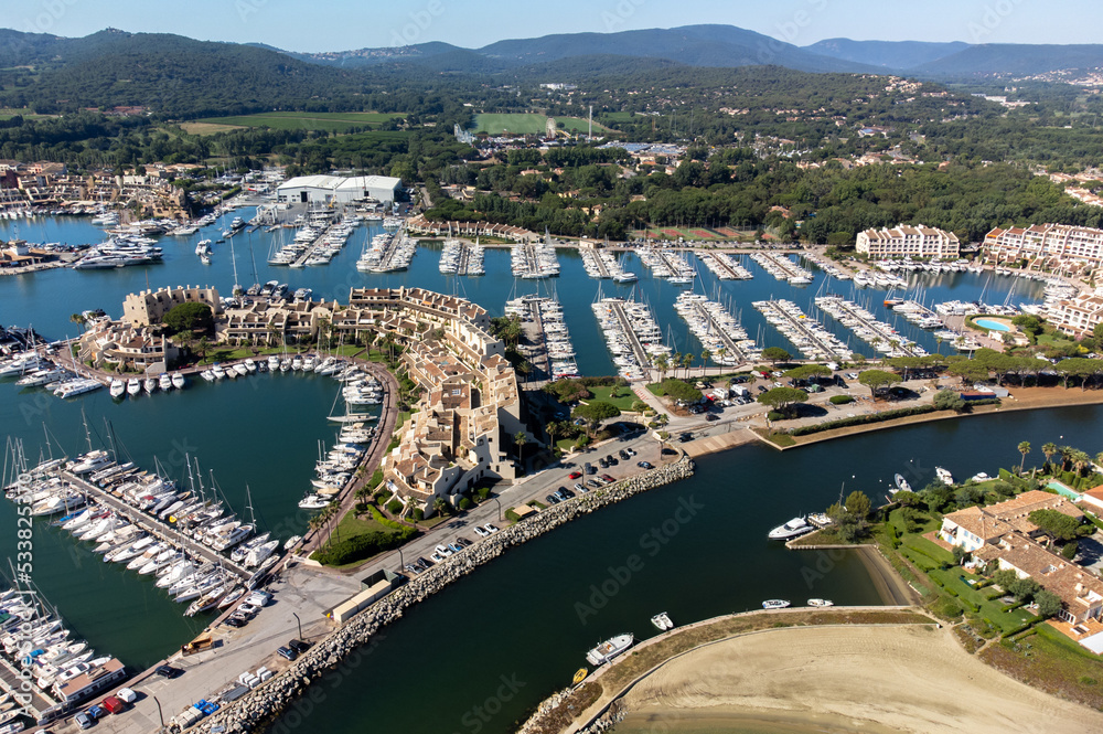 Obraz premium Aerial view on Gulf of Saint-Tropez, sail boats, houses of Port Grimaud and Port Cogolin, summer vacation in Provence, France