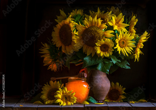 beautiful yellow Sunflower still life bouquet  in a clay jug ceramic rustic style oil honey Dark photo background wooden table Vintage. Retro. low key Autumn flowers.