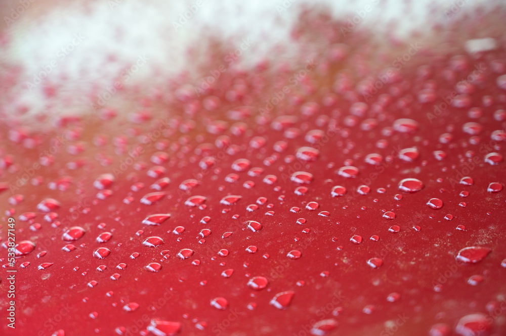 water on red hood car, transportation background