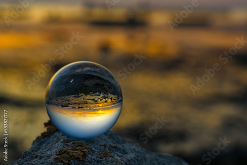 The reflection on crystal ball during sunset