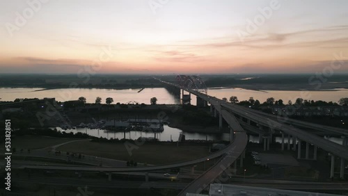 Drone Flying during Sunset around Buildings in Downtown Memphis, Tennessee with the Mississippi River Bridge in the background.