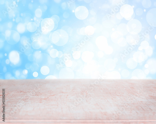 empty wooden surface on blue background with bokeh