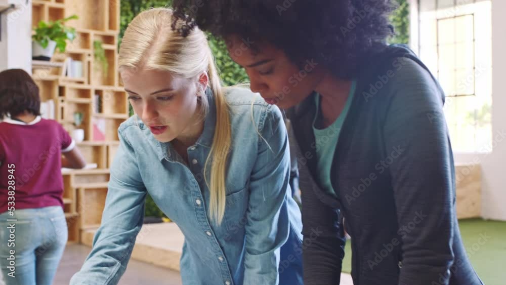 Collaboration, teamwork and women designer team working on a laptop in a modern workspace, partner discuss goal for green business. Planning, vision and web design for startup of eco friendly company