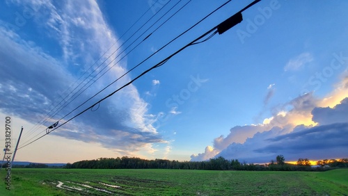 Blue and Golden Clouds Stretch Across Green Field, Nova Scotia