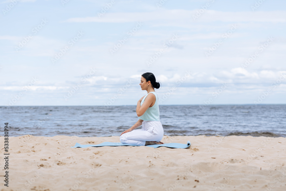 Beautiful european woman doing breathing yoga exercise in the park, European female meditation pose, healthcare. Beautiful european woman doing breathing yoga exercise in the park, European female meditation pose, healthcare.