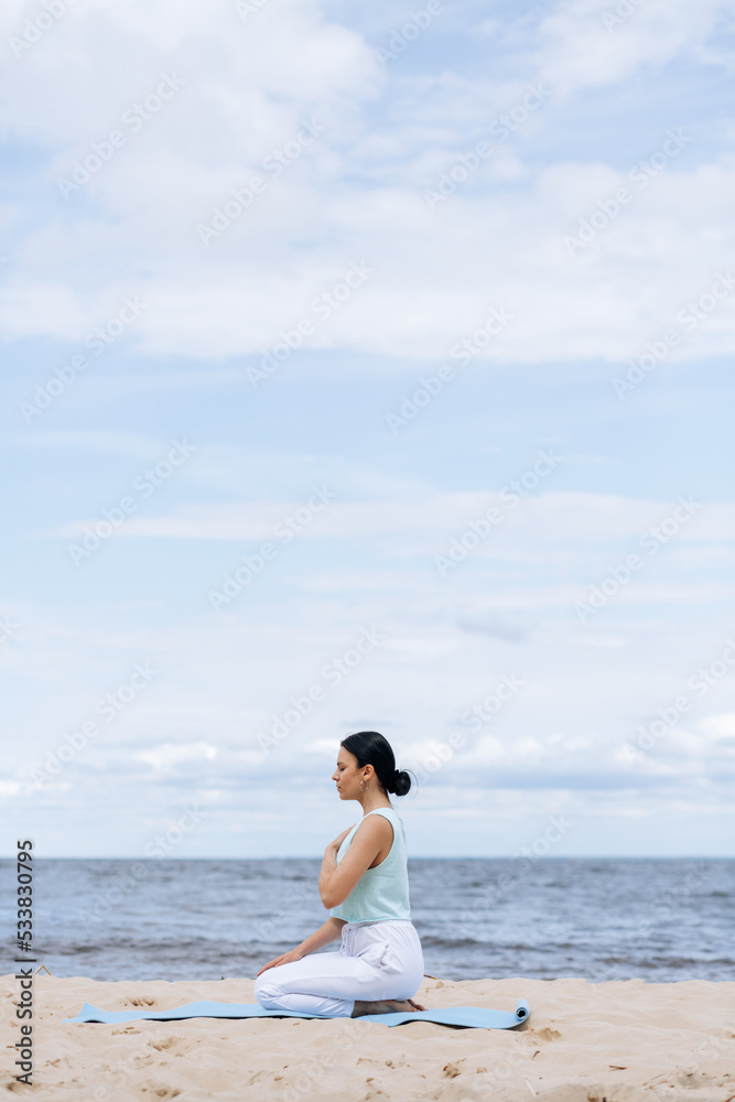 Beautiful european woman doing breathing yoga exercise in the park, European female meditation pose, healthcare. Beautiful european woman doing breathing yoga exercise in the park, European female meditation pose, healthcare.