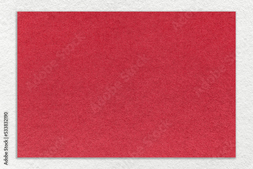 Texture of craft red color paper background with white border, macro. Structure of vintage kraft ruby cardboard © nikol85