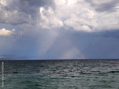 stormy weather at the sea with rainbow, Corfu island, Greece