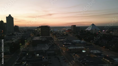 Drone Flying during Sunset around Buildings in Downtown Memphis, Tennessee with the Mississippi River Bridge in the background.