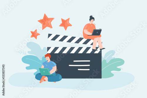 Film making process flat vector illustration. Tiny male and female character working on laptops near huge clapperboard. Multimedia, production concept for banner, website design or landing web page