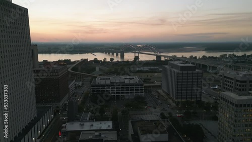 Drone Flying during Sunset around Buildings in Downtown Memphis, Tennessee with the Mississippi River Bridge in the background.