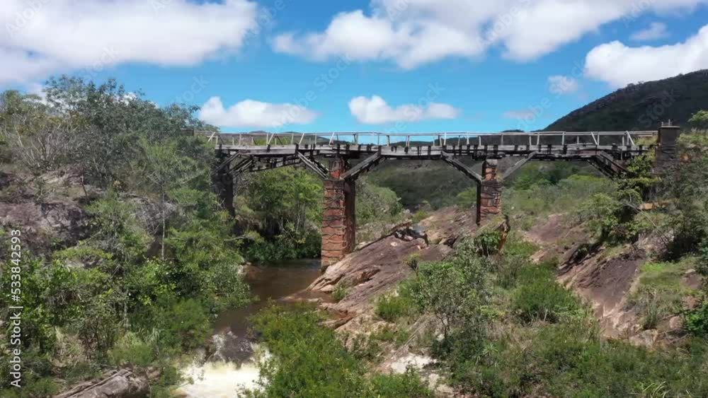 an old abandoned bridge crosses the river in the barren hills. 4K videos. approaching shot. an old abandoned bridge crosses the river in the barren hills. 4K videos. approaching shot.
