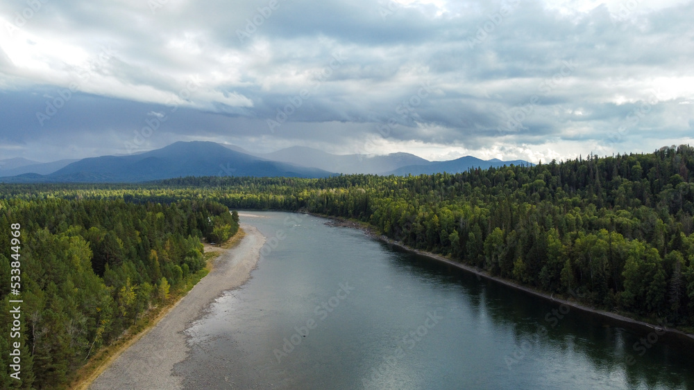 Wild nature landscape drone view with river and forest. Fog above water. Mountain Siberian river flow, water on stones,  forest  trees. aero view.